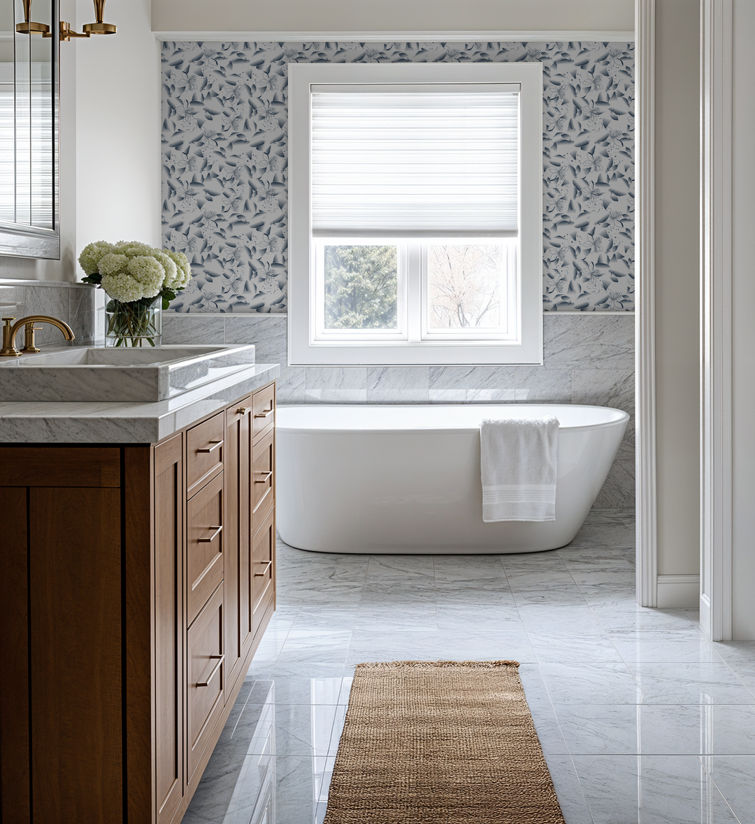 Bathroom with blue dandelion and lily floral wallpaper, white tub, and wood vanity.