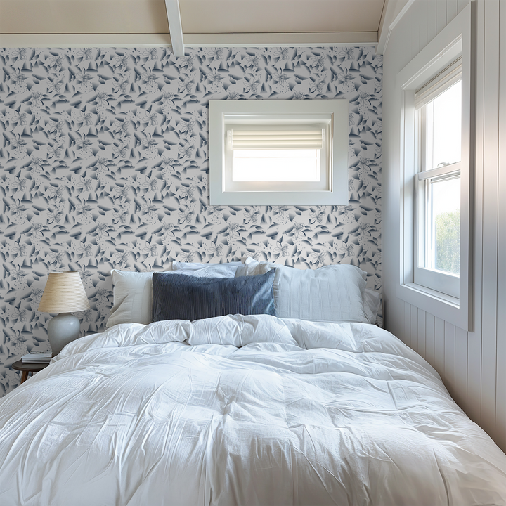 Bedroom with blue dandelion and lily floral wallpaper, white bedding, and soft lighting.