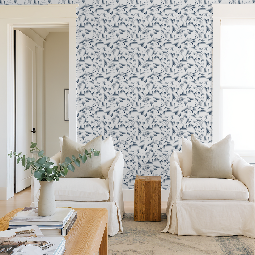 Blue dandelion and lily floral wallpaper in modern living room with white chairs.
