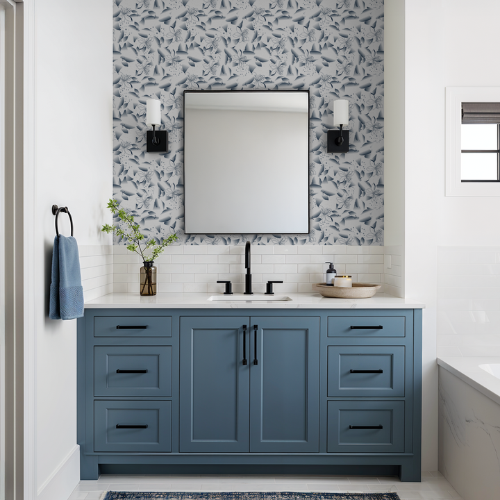 Bathroom with blue dandelion lily wallpaper, blue vanity, and modern decor.