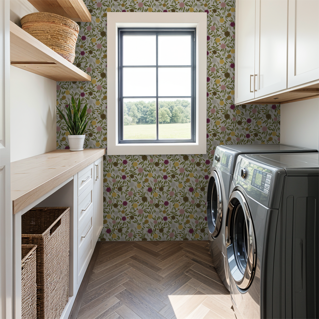 Floral wallpaper with burgundy, blush, yellow marigolds and green leaves on cream background in laundry room