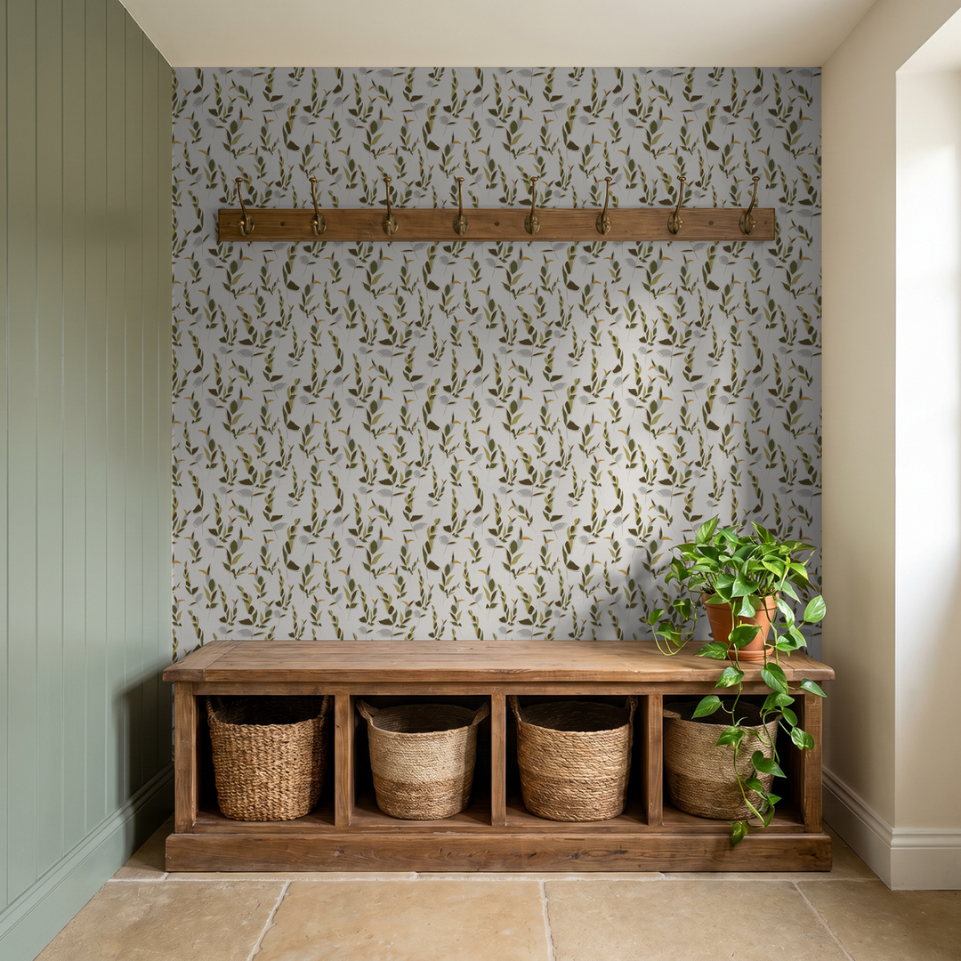 Leaf Whispers wallpaper in ivory and olive green with wooden bench and plant