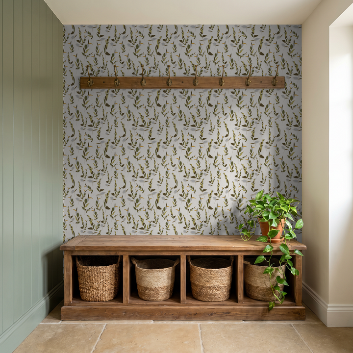 Leaf Whispers wallpaper in ivory and olive green with wooden bench and plant